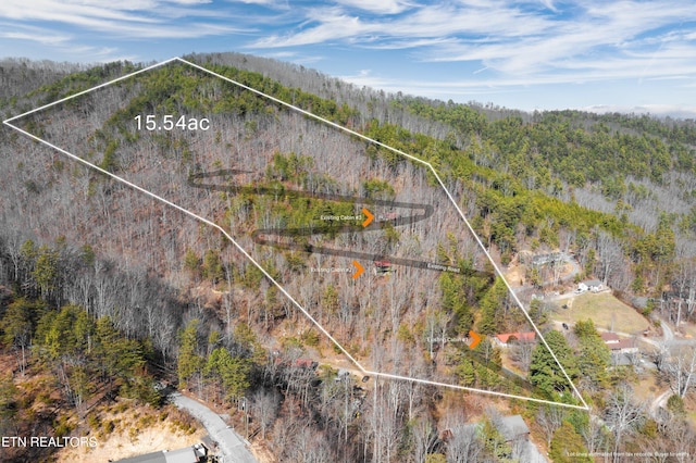 birds eye view of property with a view of trees