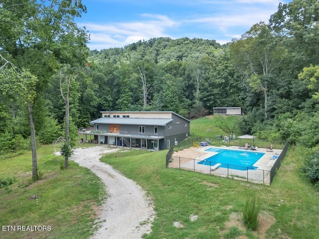 exterior space featuring a fenced in pool and a yard