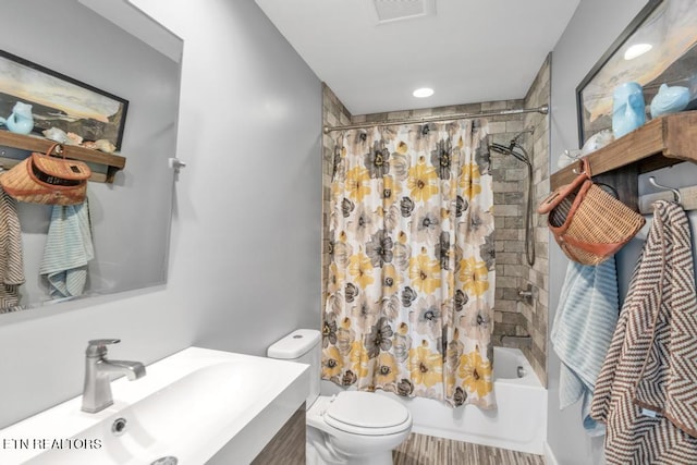 full bathroom featuring toilet, shower / bath combination with curtain, and vanity