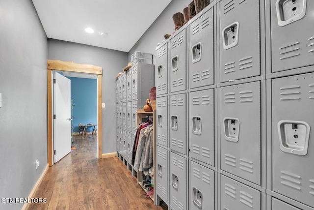 corridor featuring a package area and hardwood / wood-style flooring