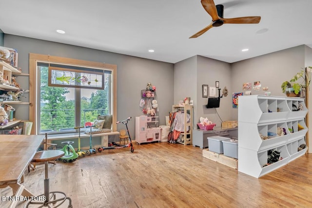 game room with ceiling fan and light wood-type flooring