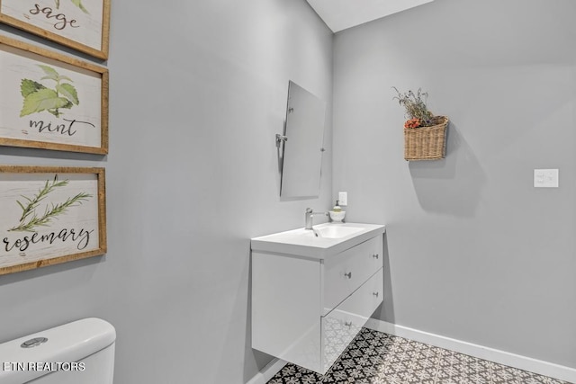 bathroom featuring vanity, toilet, and tile patterned flooring