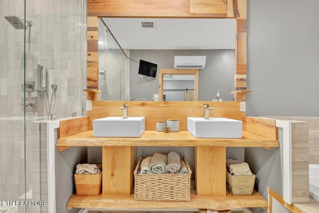 bathroom featuring an AC wall unit, sink, and an enclosed shower