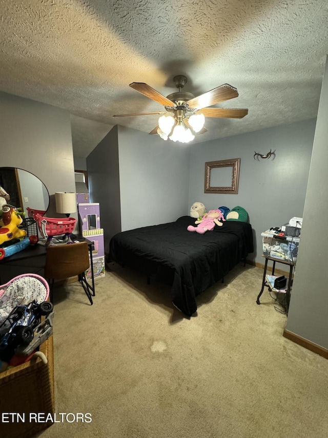 bedroom featuring light carpet, a textured ceiling, and ceiling fan