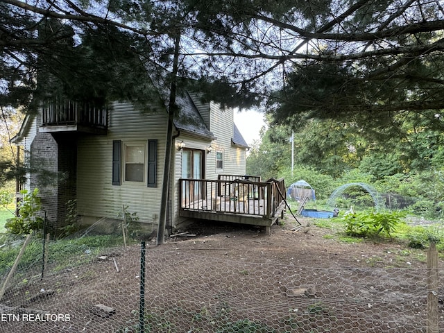 view of side of property with a wooden deck