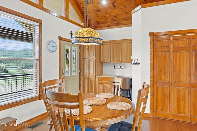 dining space with wooden ceiling, hardwood / wood-style flooring, vaulted ceiling, and a healthy amount of sunlight