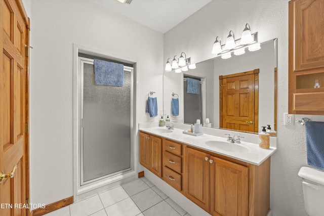 bathroom featuring dual vanity, tile patterned floors, a shower with door, and toilet