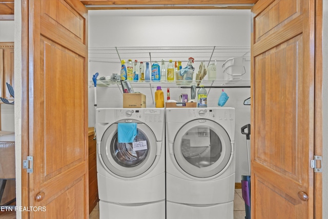 clothes washing area featuring light tile patterned flooring and independent washer and dryer