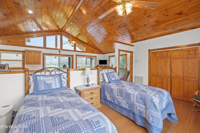 bedroom featuring wood ceiling, ceiling fan, lofted ceiling, light hardwood / wood-style floors, and a closet