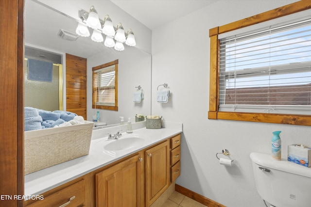 bathroom featuring vanity, tile patterned flooring, and toilet