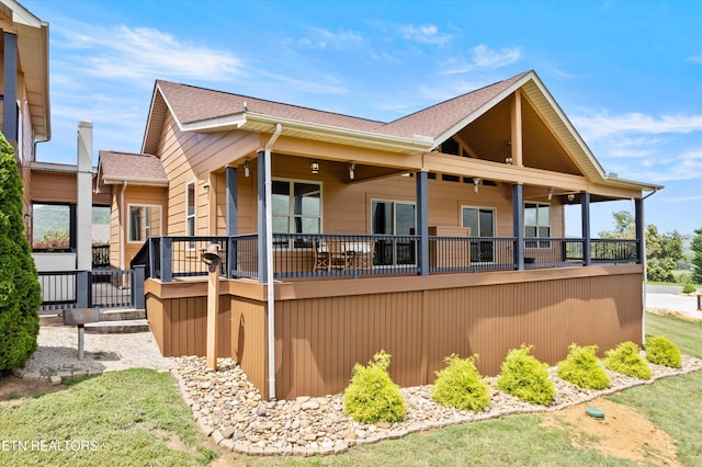 rear view of property featuring covered porch