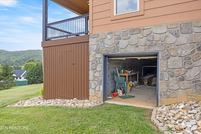 exterior space featuring a lawn and a balcony