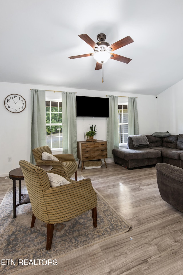 living room featuring ceiling fan and light wood-type flooring