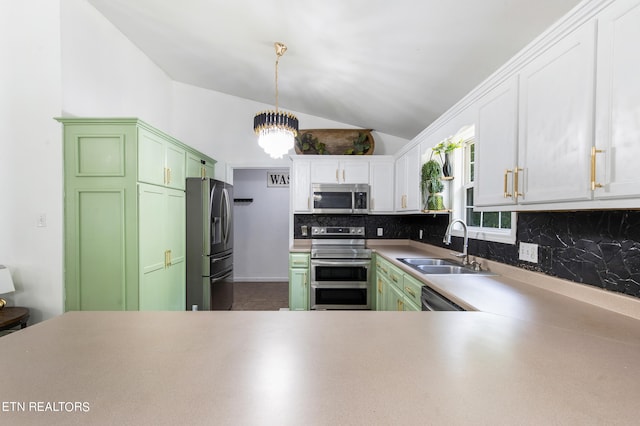 kitchen with appliances with stainless steel finishes, decorative backsplash, sink, kitchen peninsula, and vaulted ceiling