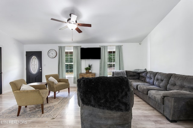 living room featuring light hardwood / wood-style floors, a wealth of natural light, and ceiling fan