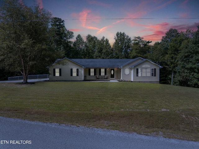 ranch-style home with a yard