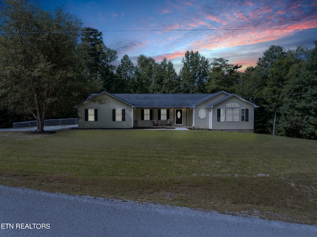 ranch-style home featuring a yard