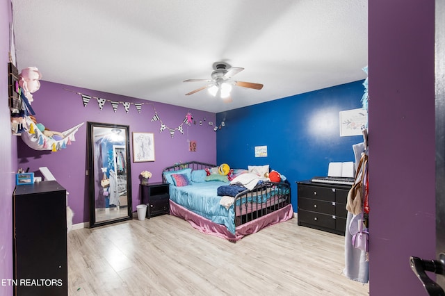 bedroom featuring ceiling fan and light hardwood / wood-style floors