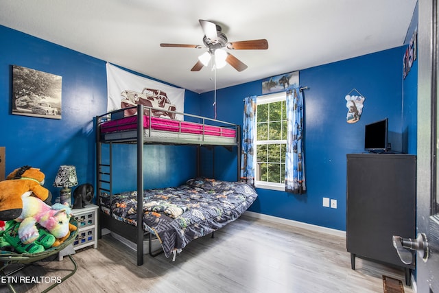 bedroom with ceiling fan and light wood-type flooring