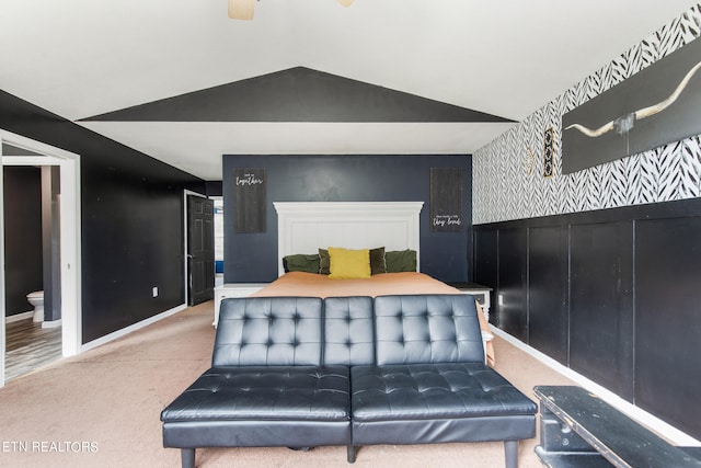 carpeted bedroom featuring ceiling fan, connected bathroom, and lofted ceiling