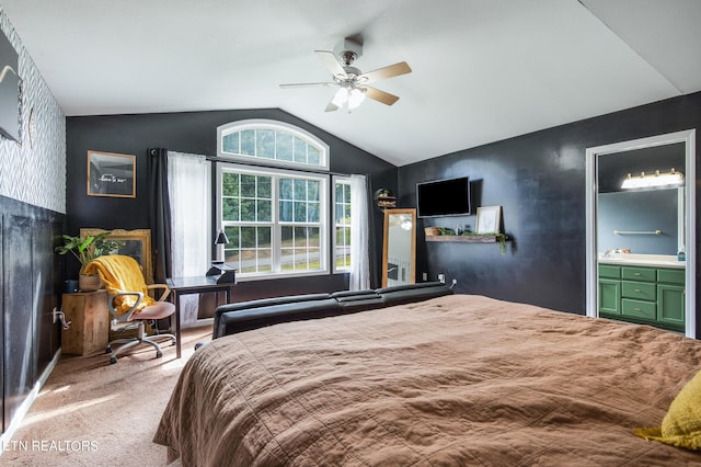 bedroom with carpet floors, ensuite bath, ceiling fan, and lofted ceiling