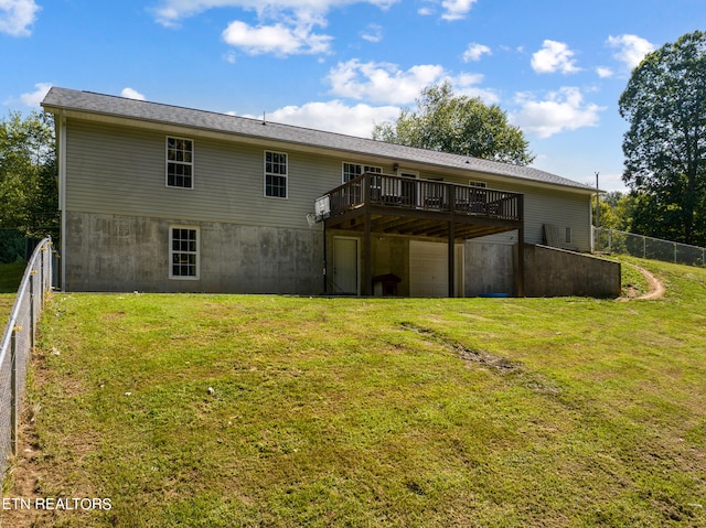 rear view of property with a deck and a lawn