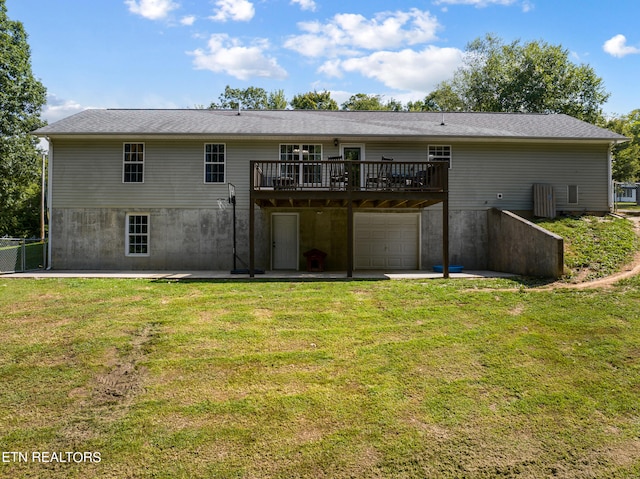 rear view of property with a deck and a yard