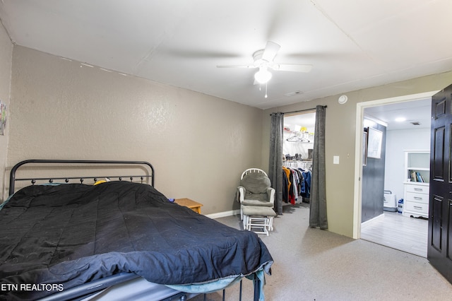 bedroom with ceiling fan, a spacious closet, wood-type flooring, and a closet