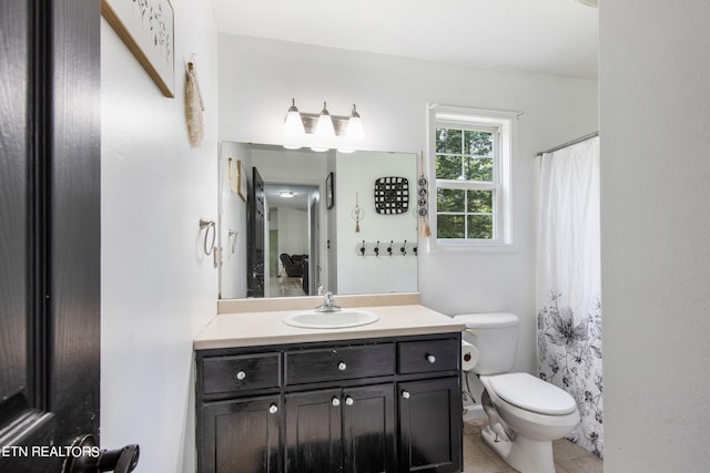 bathroom with tile patterned flooring, toilet, a shower with shower curtain, and vanity