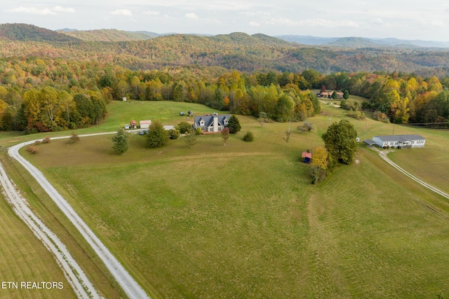 bird's eye view featuring a rural view, a mountain view, and a wooded view