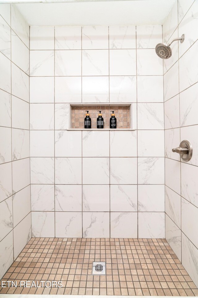 bathroom with a tile shower