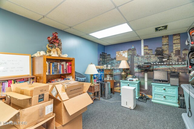 carpeted office with a drop ceiling