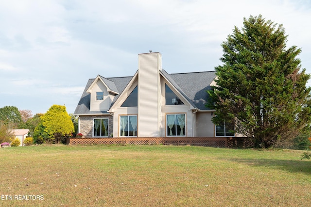 back of property featuring a chimney and a yard