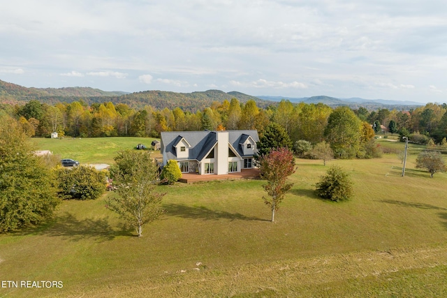 birds eye view of property with a forest view and a mountain view