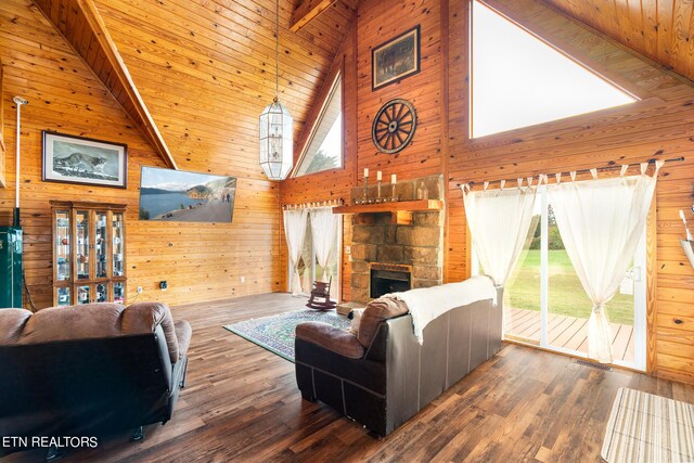 living room with wooden ceiling, wooden walls, hardwood / wood-style floors, and high vaulted ceiling