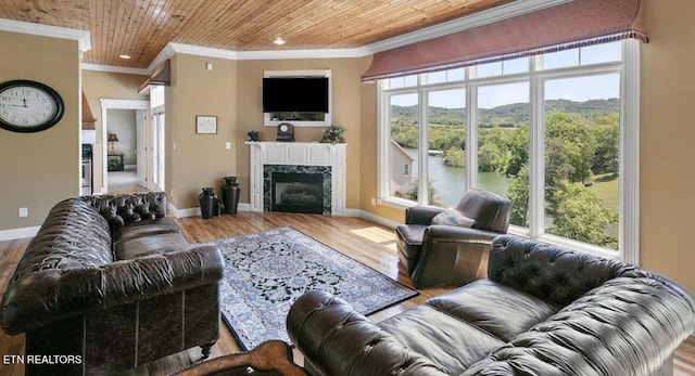 living room with plenty of natural light, light hardwood / wood-style flooring, a premium fireplace, and wooden ceiling