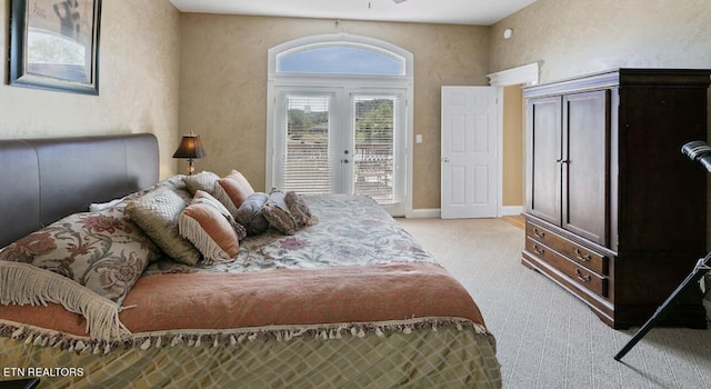 carpeted bedroom featuring french doors and access to outside