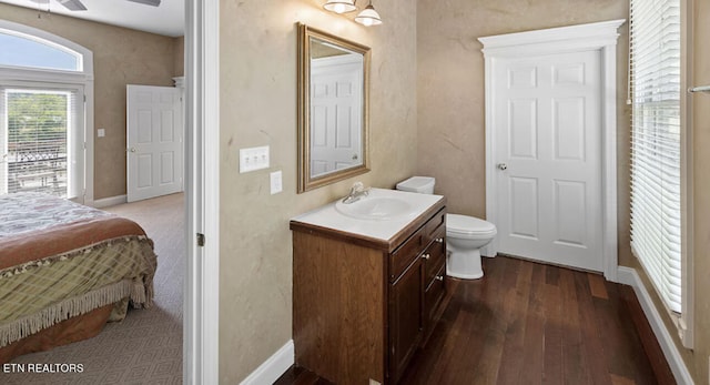 bathroom with ceiling fan, vanity, toilet, and hardwood / wood-style floors