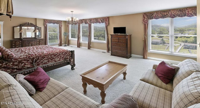 carpeted bedroom featuring a notable chandelier