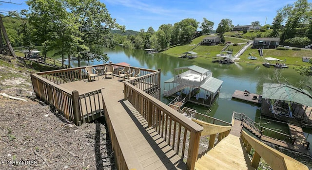 dock area featuring a deck with water view