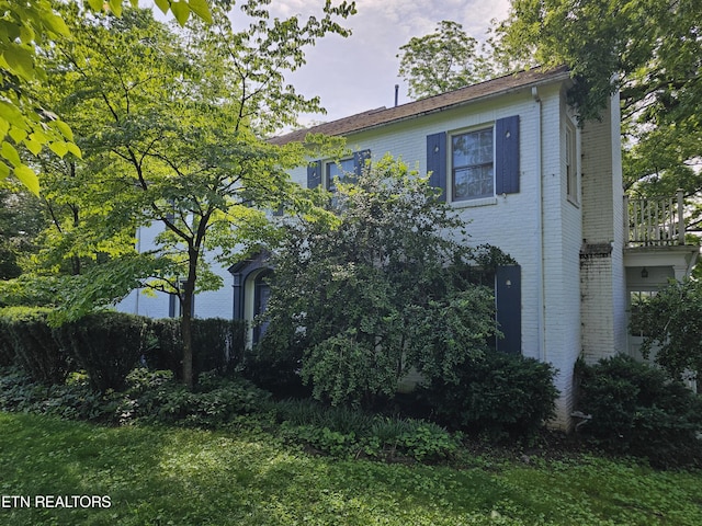 view of home's exterior with brick siding