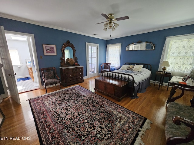 bedroom with crown molding, baseboards, and wood finished floors