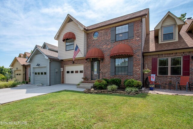 view of front of house with a garage and a front lawn