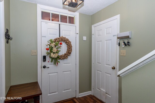 foyer with a textured ceiling and hardwood / wood-style flooring