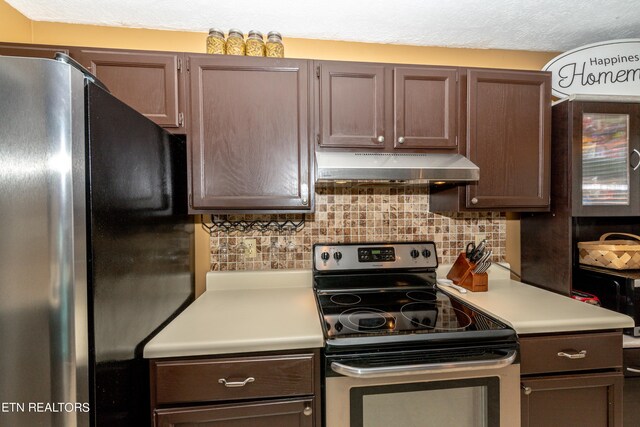 kitchen featuring appliances with stainless steel finishes, backsplash, and a textured ceiling