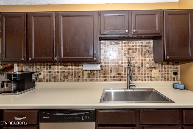 kitchen featuring decorative backsplash, sink, and dishwashing machine