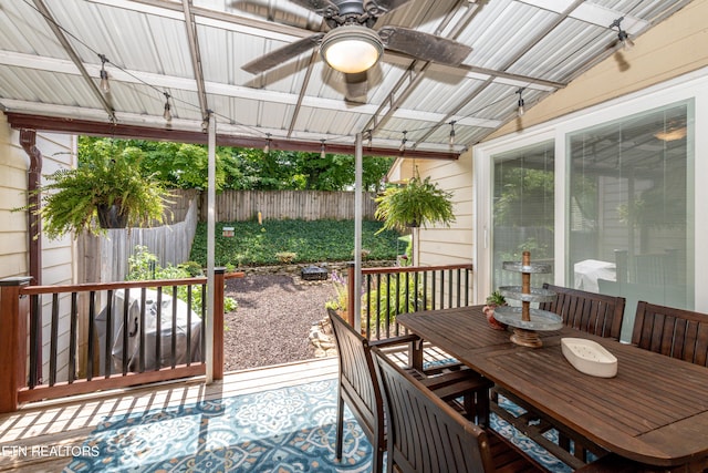 sunroom / solarium with ceiling fan and vaulted ceiling