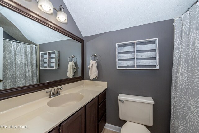 bathroom featuring vanity, vaulted ceiling, a textured ceiling, and toilet