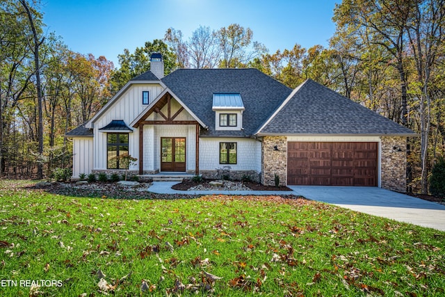 view of front of house featuring a front yard and a garage