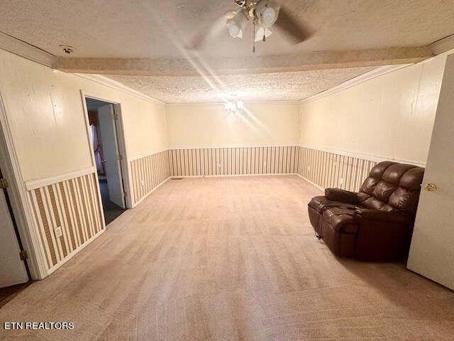 unfurnished room featuring ceiling fan, carpet floors, and a textured ceiling